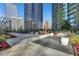 Relaxing outdoor lounge area featuring comfortable seating, lush landscaping, and scenic city views at 1080 Peachtree Ne St # 2003, Atlanta, GA 30309