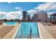 Inviting rooftop pool with city views, lounge chairs, and a shallow area for relaxation at 1080 Peachtree Ne St # 2003, Atlanta, GA 30309