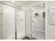 Bright white bathroom with walk-in shower and access to closet for storage creating a spa-like experience at 1216 Arnhem Dr, Hampton, GA 30228