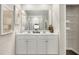Bathroom boasts double sinks, a large mirror, neutral decor and access to a closet with shelving at 1216 Arnhem Dr, Hampton, GA 30228