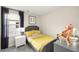 Cozy bedroom features a twin bed, a white nightstand, a window and decorative pillows and stuffed animals at 1216 Arnhem Dr, Hampton, GA 30228