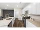 Modern kitchen boasts stainless steel appliances, granite countertops, and wooden floors at 1216 Arnhem Dr, Hampton, GA 30228