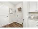 Bright laundry room with white cabinets and a handy utility sink at 1216 Arnhem Dr, Hampton, GA 30228