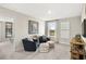 Upstairs loft with a reading nook and cozy chairs by a window view at 1216 Arnhem Dr, Hampton, GA 30228