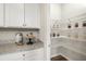 Walk-in pantry with white wire shelving and extra countertop space at 1216 Arnhem Dr, Hampton, GA 30228