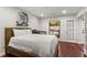 Bright bedroom features hardwood floors, modern art, and access to a balcony through glass French doors at 3203 Lenox Ne Rd # 1, Atlanta, GA 30324