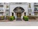 Welcoming condo building entrance at the St James at Buckhead with a black awning and decorative golden door at 3203 Lenox Ne Rd # 1, Atlanta, GA 30324