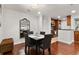 Dining room with hardwood flooring, a modern chandelier, and natural light with an open floor plan to the kitchen at 3203 Lenox Ne Rd # 1, Atlanta, GA 30324