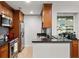 Well-equipped kitchen featuring wood cabinets, stainless appliances, and a bar area at 3203 Lenox Ne Rd # 1, Atlanta, GA 30324