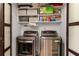 Convenient laundry room equipped with modern washer and dryer and storage shelving at 3203 Lenox Ne Rd # 1, Atlanta, GA 30324