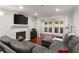 Contemporary living room with a fireplace, flat screen television, and doors that open to a private balcony at 3203 Lenox Ne Rd # 1, Atlanta, GA 30324