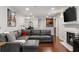 Open-concept living room with dark hardwood floors, fireplace, and a large sectional couch and recessed lighting at 3203 Lenox Ne Rd # 1, Atlanta, GA 30324
