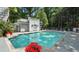 Community pool with beautiful landscaping, lounge chairs, and umbrellas at 3203 Lenox Ne Rd # 1, Atlanta, GA 30324