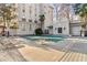 Condo building with a shared pool area featuring lounge chairs and a tranquil outdoor space at 3203 Lenox Ne Rd # 1, Atlanta, GA 30324