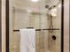 Modern glass shower with bronze fixtures and textured tiles create a spa-like experience at 3203 Lenox Ne Rd # 1, Atlanta, GA 30324