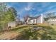 A backyard featuring a fire pit, a lawn area, and some trees near the back of the property at 785 Josh Ln, Lawrenceville, GA 30045