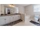 Ensuite bathroom featuring granite vanity, white cabinets, and tub at 785 Josh Ln, Lawrenceville, GA 30045