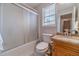 Bathroom featuring a shower-tub, granite vanity, and natural light at 785 Josh Ln, Lawrenceville, GA 30045