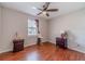 Bedroom featuring hardwood floors, a ceiling fan, and a window for natural light at 785 Josh Ln, Lawrenceville, GA 30045