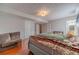 Spacious bedroom featuring hardwood floors, neutral walls, textured ceiling, and a glimpse into the bathroom at 785 Josh Ln, Lawrenceville, GA 30045