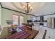 Bright dining room with modern lighting and a view into the updated kitchen at 785 Josh Ln, Lawrenceville, GA 30045