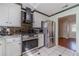 Well-lit kitchen with stainless steel appliances, black tile backsplash, and granite countertops at 785 Josh Ln, Lawrenceville, GA 30045