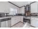 Bright kitchen with white cabinets, granite counters, stainless appliances, and black tile backsplash at 785 Josh Ln, Lawrenceville, GA 30045