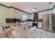 Eat-in kitchen boasts an island with bar stools, stainless appliances, and bright, natural light at 785 Josh Ln, Lawrenceville, GA 30045