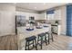 Bright kitchen with white cabinets, stainless steel appliances, and a granite-topped island with seating at 1220 Arnhem Dr, Hampton, GA 30228