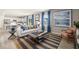 Bright living room with open floor plan, modern decor, and luxury vinyl plank flooring at 1220 Arnhem Dr, Hampton, GA 30228
