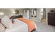 Bedroom view with large bed, dresser, modern art, and view into the bathroom at 1220 Arnhem Dr, Hampton, GA 30228