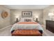 Comfortable bedroom with king bed, upholstered bench, and modern decor at 1220 Arnhem Dr, Hampton, GA 30228