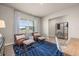 Cozy sitting area with large windows, brown leather chairs, and blue geometric rug at 1220 Arnhem Dr, Hampton, GA 30228