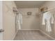 Bright walk-in closet with white wire shelving and neutral carpet flooring at 1220 Arnhem Dr, Hampton, GA 30228