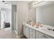 A bathroom with double sinks, white cabinets, and a walk-in shower at 1618 Blossom Dr, Atlanta, GA 30349