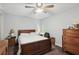 This bedroom features a bed and dresser with neutral gray walls and carpeted floors at 1618 Blossom Dr, Atlanta, GA 30349
