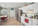 Bright kitchen features stainless steel appliances, white cabinetry, and an adjacent dining area at 1618 Blossom Dr, Atlanta, GA 30349