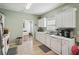 Spacious kitchen showcasing white cabinets, stainless steel sink and window at 1618 Blossom Dr, Atlanta, GA 30349