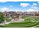 Lush green amphitheater with lake, surrounded by brick buildings against blue sky at 400 Eagle Tiff Dr, Sugar Hill, GA 30518