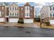 Charming brick townhomes feature attached garages, creating curb appeal and convenient parking at 400 Eagle Tiff Dr, Sugar Hill, GA 30518