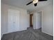 Neutral bedroom with carpet, double closets, and a ceiling fan with decorative lights at 301 Windswept Ct, Powder Springs, GA 30127