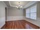 Dining room with tray ceiling, chandelier, and large window with natural light at 301 Windswept Ct, Powder Springs, GA 30127