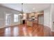 Bright kitchen with an island, wood cabinets, pendant lighting, and hardwood floors at 301 Windswept Ct, Powder Springs, GA 30127