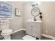 Updated bathroom features a modern vanity, round mirror, and stylish lighting fixture at 3395 Lake Valley Nw Rd, Atlanta, GA 30331