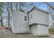 Rear exterior view of a home with gray siding and a block foundation with separate entrances at 3395 Lake Valley Nw Rd, Atlanta, GA 30331