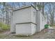 View of the home's back exterior, showing the siding and concrete block foundation at 3395 Lake Valley Nw Rd, Atlanta, GA 30331