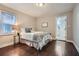 Comfortable bedroom features hardwood floors and a view of the en suite bathroom at 3395 Lake Valley Nw Rd, Atlanta, GA 30331