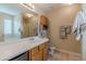 Neutral bathroom featuring a vanity, commode, linen storage, and decorative towels and hardware at 71 Farm St, Hiram, GA 30141
