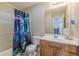 Bathroom with a patterned shower curtain and a wood vanity at 71 Farm St, Hiram, GA 30141