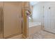 Bathroom features a shower, soaking tub, linen and toiletry storage, and natural light at 71 Farm St, Hiram, GA 30141